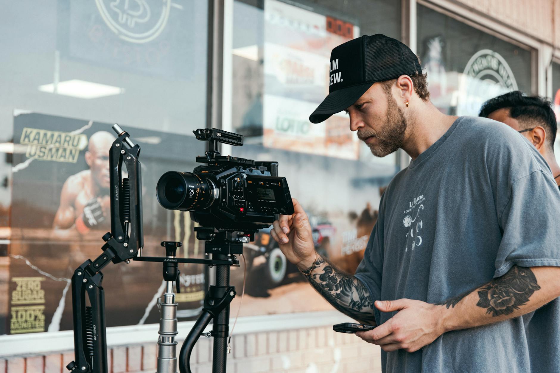 a man holding a camera and a tripod