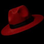 Suse Linux vs RedHat Linux, Which One to Choose in 2025 man wearing red polo shirt and red trilby hat