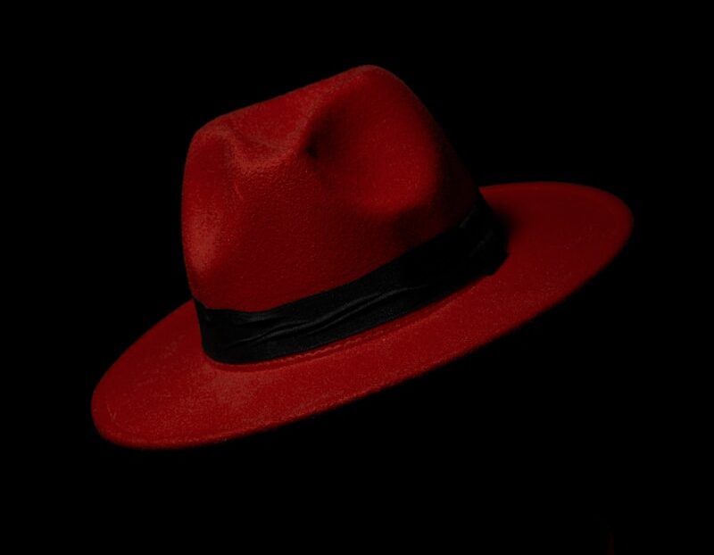 man wearing red polo shirt and red trilby hat